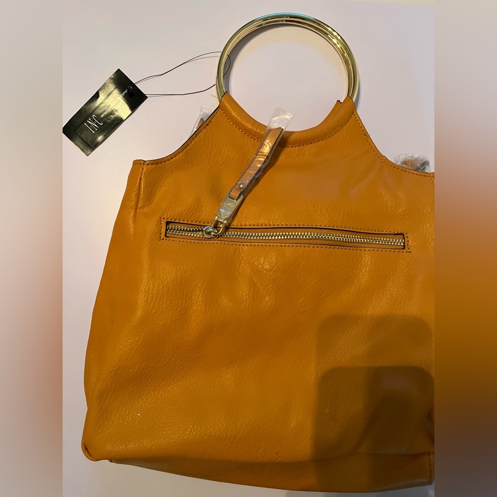 Mustard gold bag. Stylish and in good condition. Never worn. Tags on bag. Mark